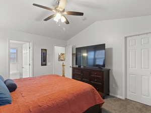 Bedroom with light colored carpet, lofted ceiling, and a ceiling fan