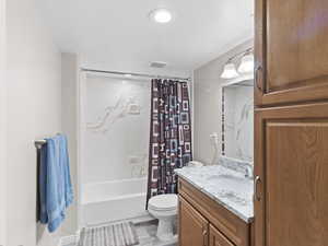 Full bath featuring vanity and shower / bathtub combination with curtain