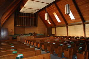 Chapel room featuring high vaulted ceiling, skylights, and beam ceiling
