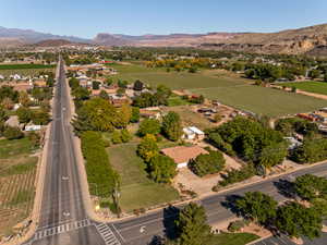 View of rural area with a mountain backdrop and extensive farmland