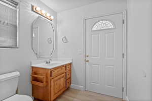 Half bath featuring vanity and light wood-style flooring