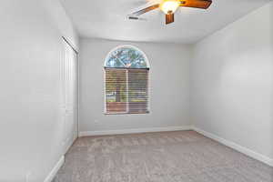 Unfurnished room featuring light carpet and ceiling fan