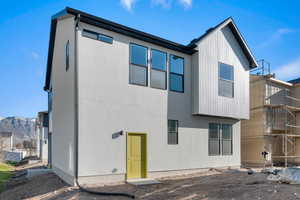 Back of property featuring a mountain view and stucco siding