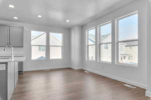 Unfurnished dining area with light wood-style floors, recessed lighting, and a textured ceiling