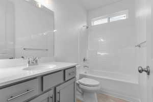 Bathroom featuring shower / tub combination and vanity