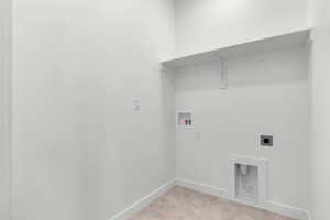 Washroom featuring hookup for a washing machine, hookup for an electric dryer, and light carpet