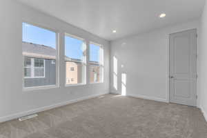 Spare room with light carpet and recessed lighting