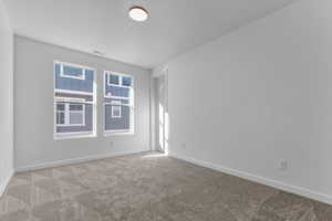Unfurnished room with carpet and baseboards