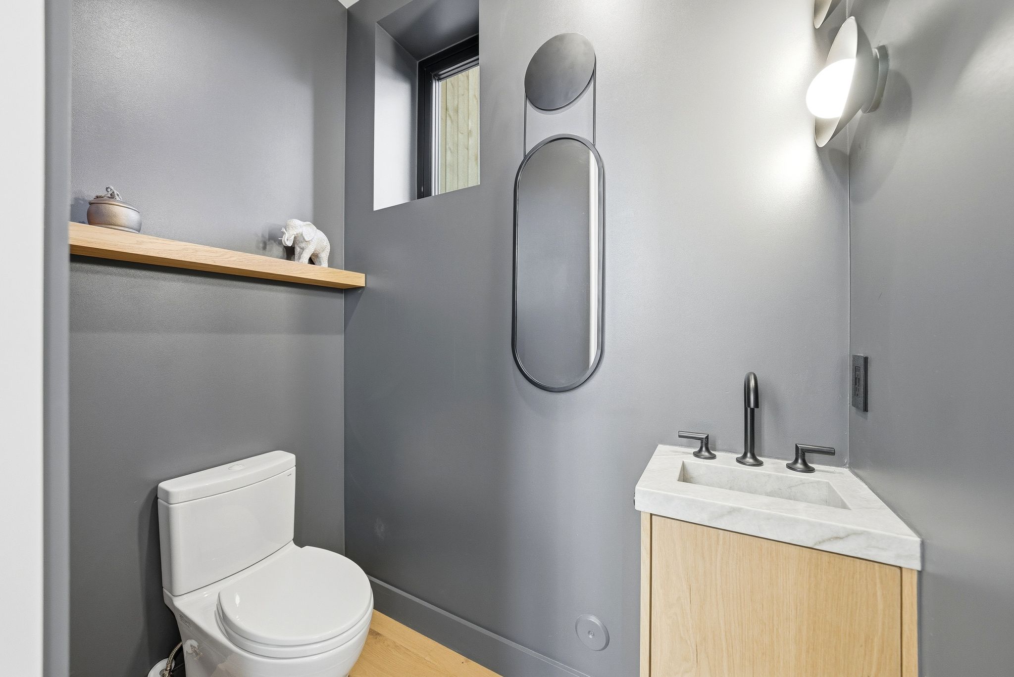 Half bathroom with vanity and toilet