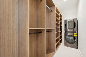 Spacious closet featuring estacked washer and dryer