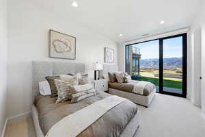 Carpeted bedroom with access to exterior, floor to ceiling windows, a mountain view, and recessed lighting