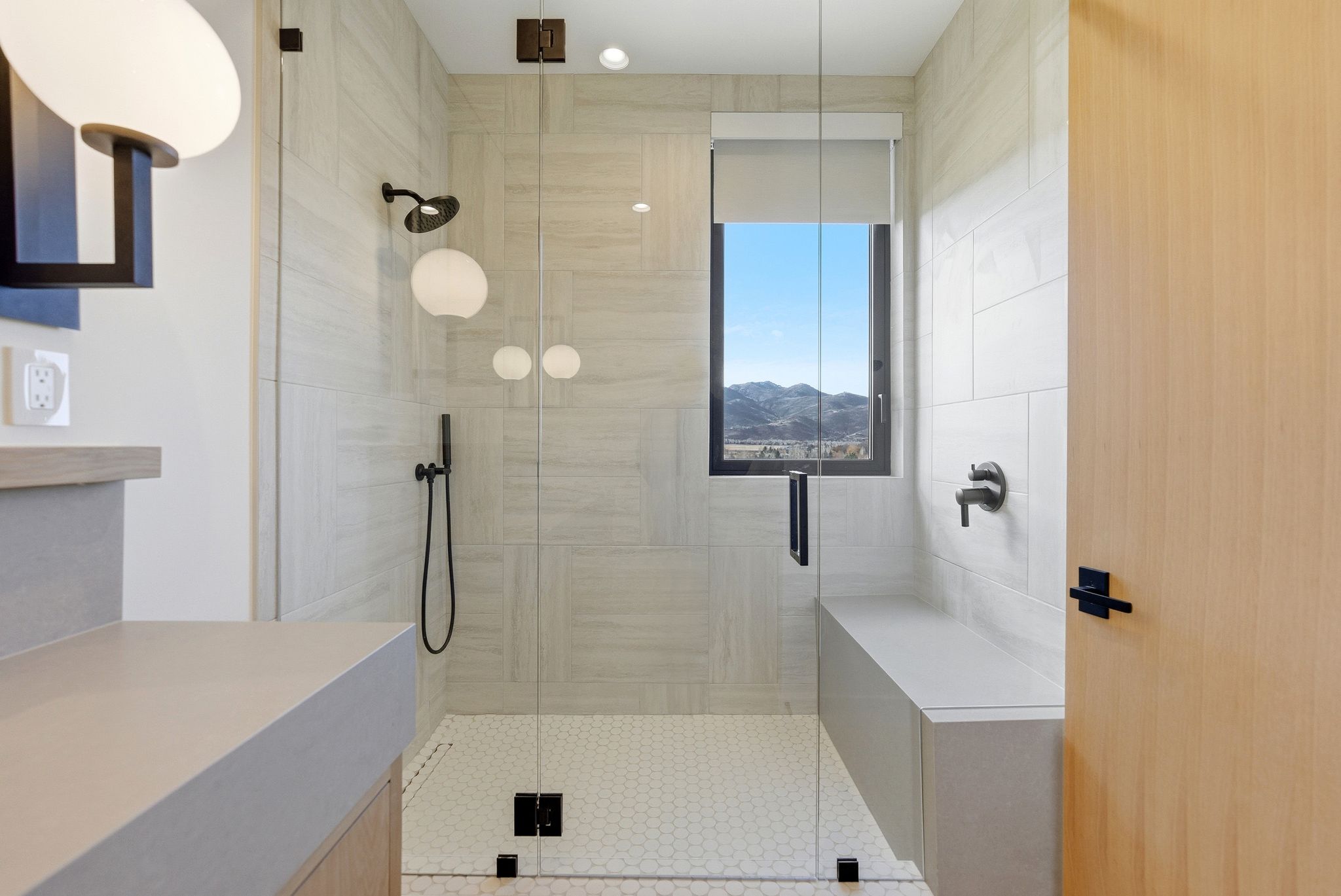 Bathroom with a shower stall and a mountain view