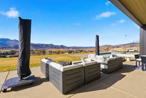 View of patio with outdoor lounge area and a mountain view