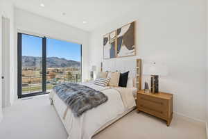 Bedroom featuring a mountain view, carpet, and recessed lighting