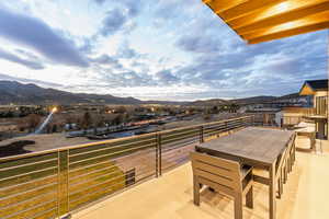 Balcony with a mountain view and outdoor dining area