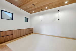 Spare room with wood ceiling, recessed lighting, and light wood-style flooring