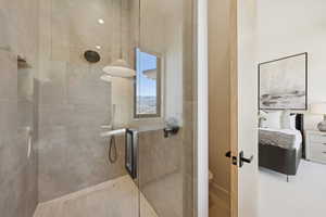 Full bathroom with ensuite bathroom and a stall shower