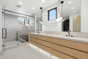 Full bathroom with double vanity, recessed lighting, light tile patterned floors, a freestanding tub, and a shower stall