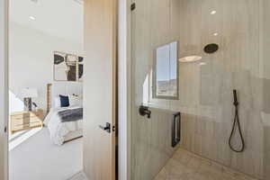 Ensuite bathroom featuring a stall shower