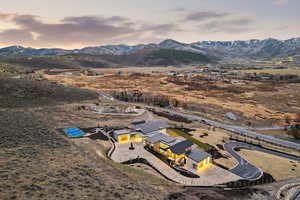 Aerial view at dusk of a mountain view and a view of rural / pastoral area