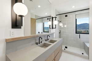 Bathroom featuring vanity, a mountain view, a stall shower, and recessed lighting