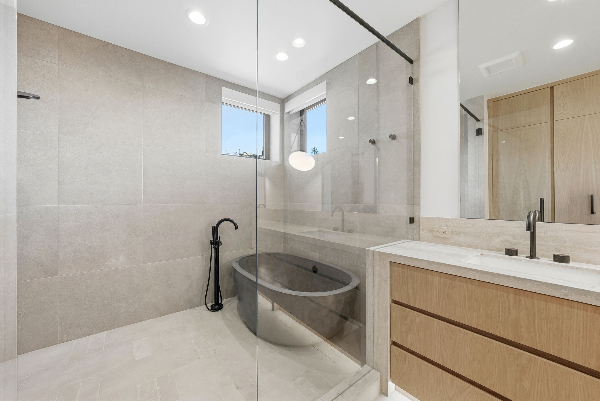 Full bath with vanity, a freestanding bath, tile walls, recessed lighting, and tiled shower