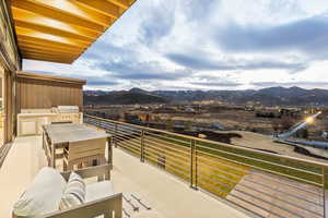 Balcony featuring a mountain view and grilling area