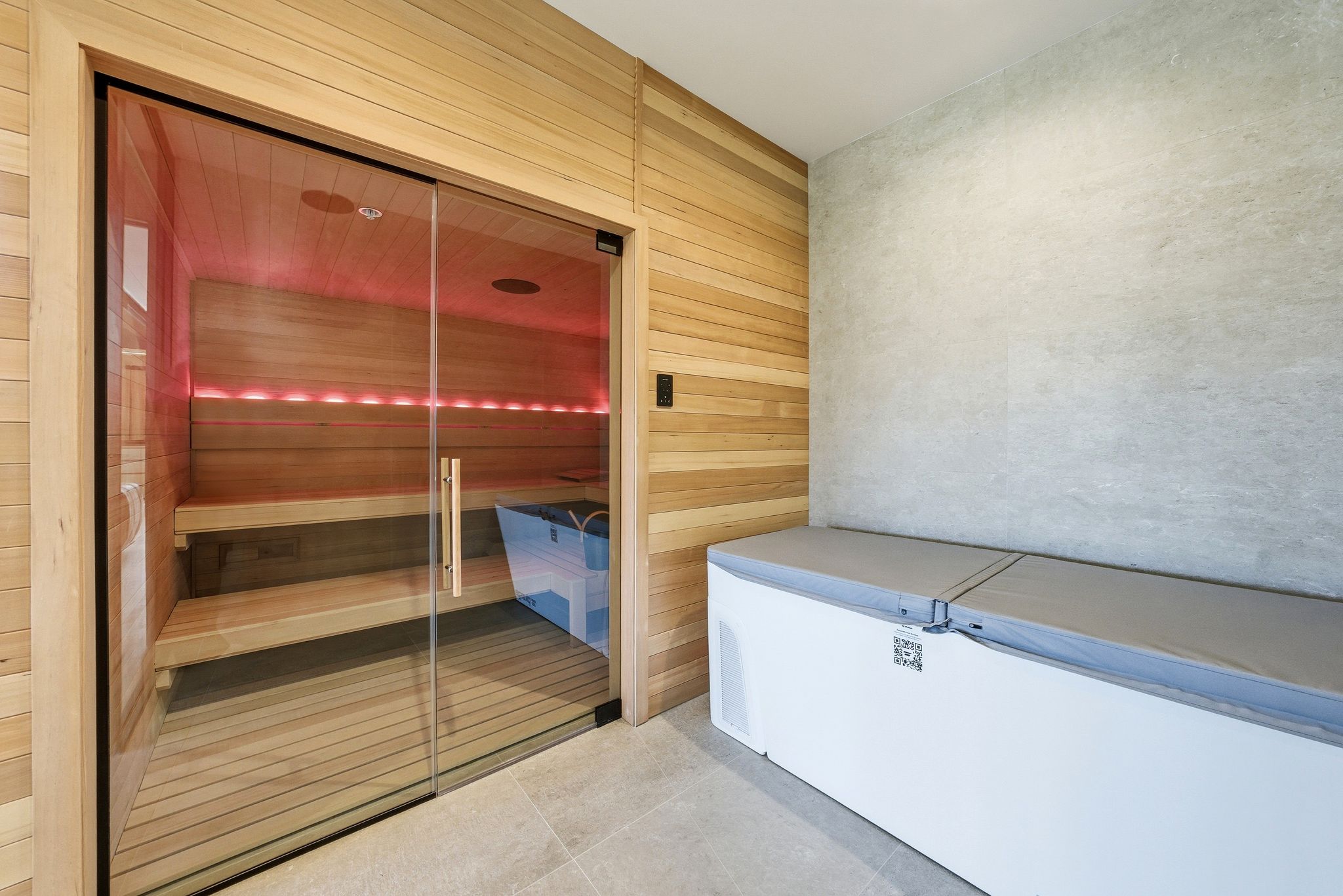 Relaxing sauna with tile patterned floors and wood walls