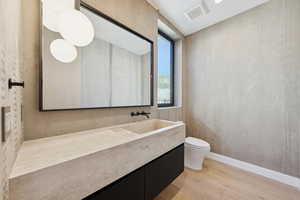 Half bath featuring light wood-style floors and vanity