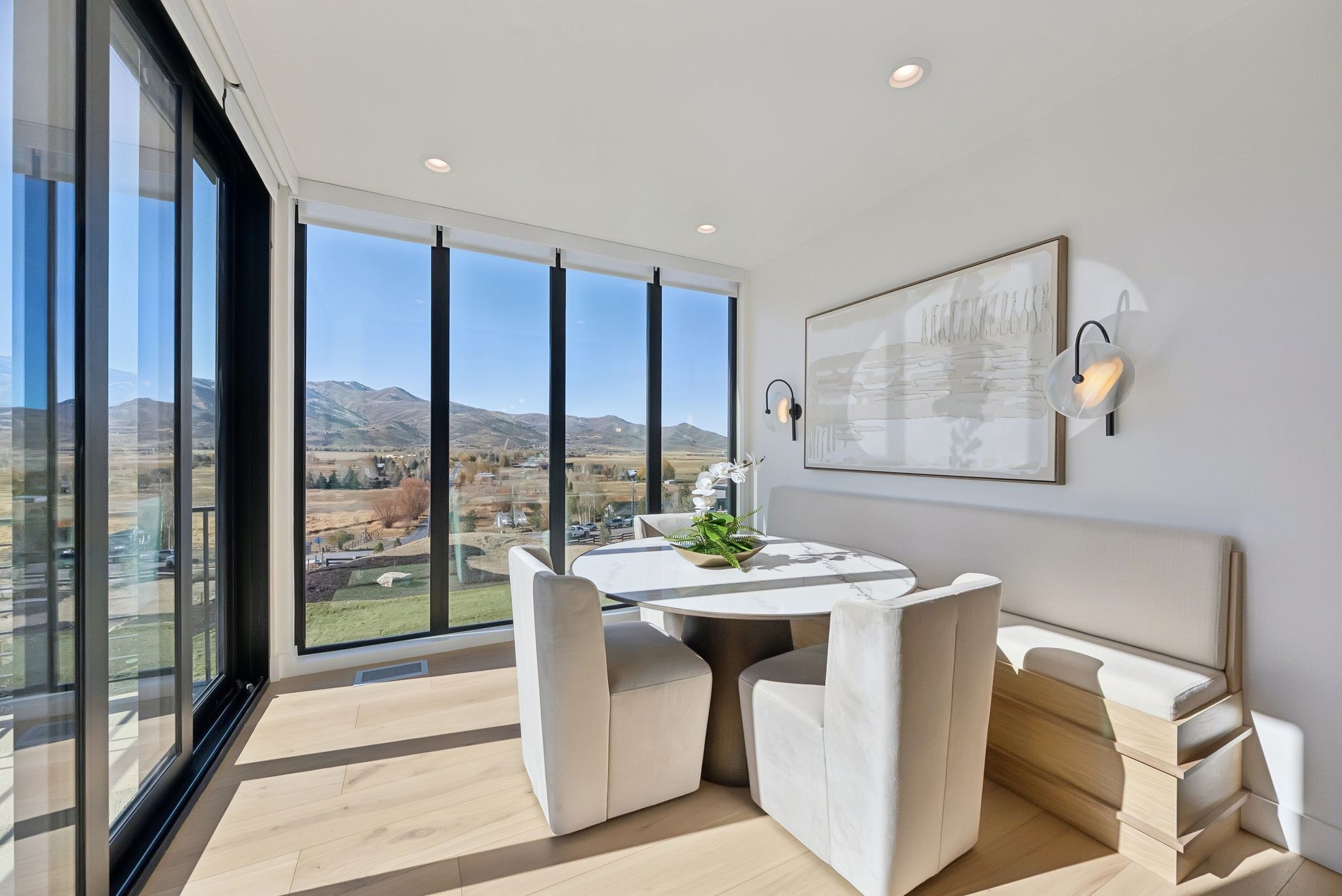 Dining room featuring floor to ceiling windows, a mountain view, light wood-style flooring, and recessed lighting