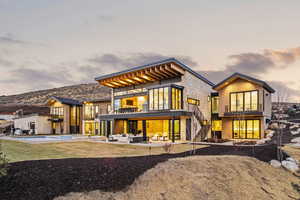 Rear view of property featuring a balcony, stairway, a patio area, outdoor lounge area, and an outdoor pool