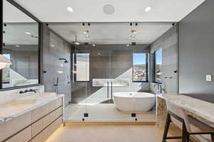 Bathroom with a soaking tub, vanity, a stall shower, recessed lighting, and light tile patterned flooring
