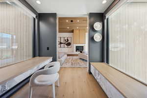 Dining area with a fireplace, light wood-type flooring, and recessed lighting