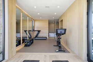 Workout room with recessed lighting and wood finished floors