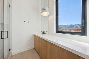 Bathroom with vanity and a shower stall
