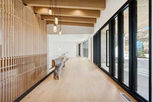 Hall with beamed ceiling and light wood finished floors