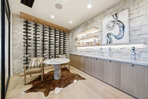 Wine area featuring light wood-type flooring and recessed lighting