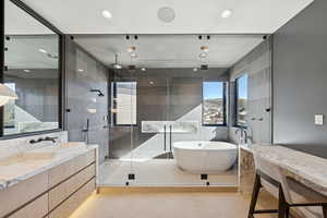 Bathroom with a freestanding bath, vanity, light tile patterned floors, a stall shower, and recessed lighting