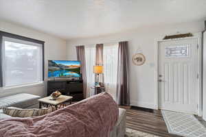 Living area with a textured ceiling and wood finished floors