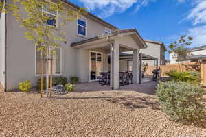 Back of house featuring a patio, stucco siding, and a tiled roof