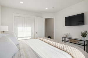 Bedroom featuring recessed lighting and a closet