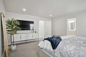 Bedroom featuring carpet, recessed lighting, and ensuite bath