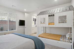 Bedroom featuring multiple windows and recessed lighting