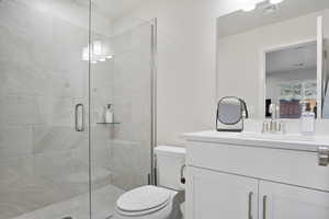 Bathroom with a stall shower and vanity