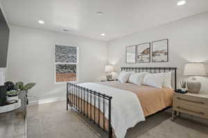 Bedroom with light carpet and recessed lighting