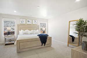 Carpeted bedroom with a textured ceiling and recessed lighting