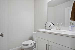 Half bath with vanity and toilet