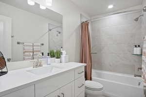 Full bath featuring shower / bathtub combination with curtain and vanity