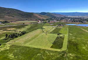 Aerial view of sparsely populated area featuring a water and mountain view and abundant farmland