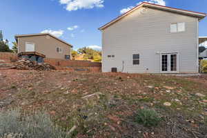 View of property exterior featuring french doors and a central air condition unit